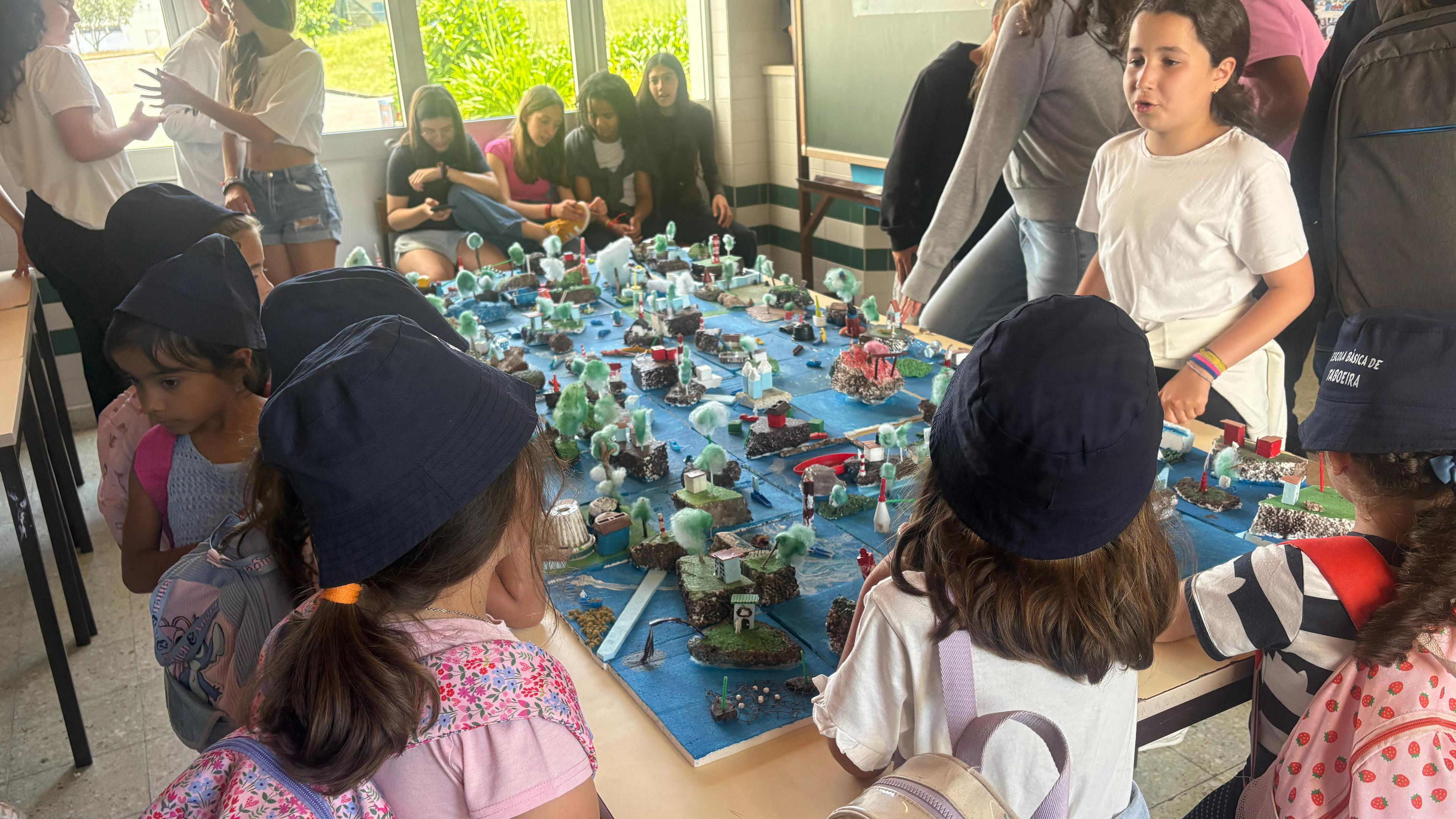 Portuguese students creating ocean-themed art with repurposed marine litter to build ocean literacy and environmental awareness.