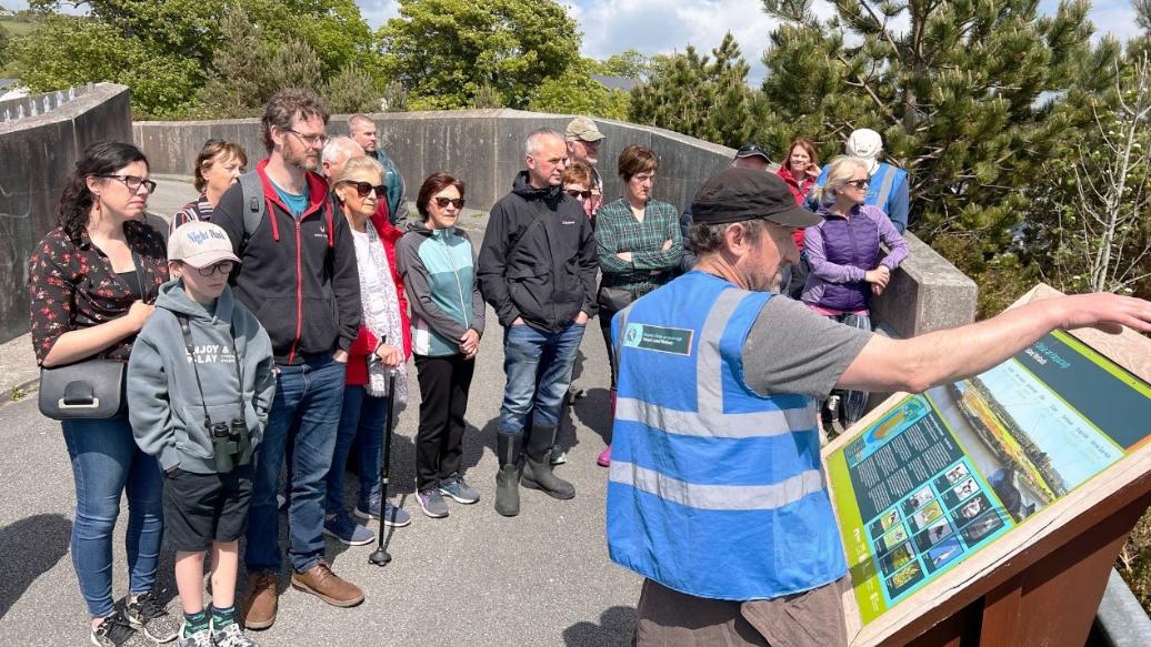 Volunteer-led community engagement tour explaining wetland restoration efforts in Ireland