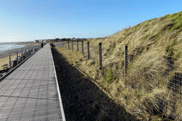 Sustainable coastal boardwalk protecting dune habitats from erosion in Cork County, Ireland.